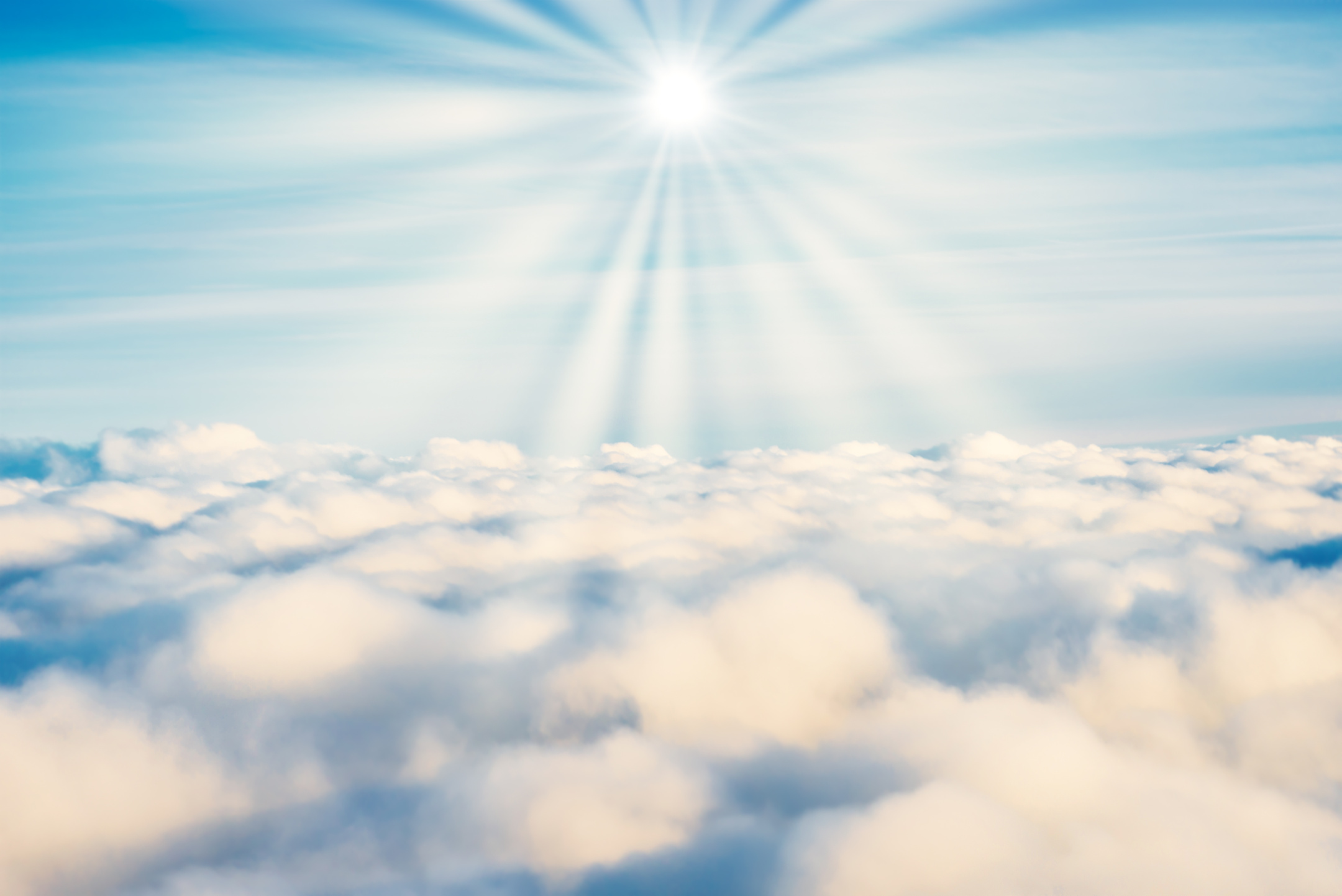 White Clouds on Blue Sky with Sun Rays